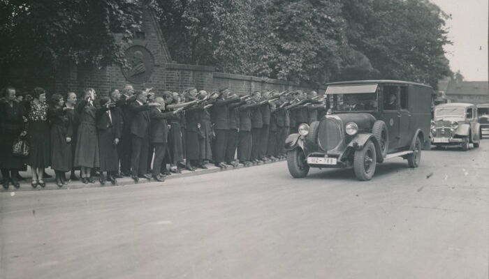 Car passes crowd