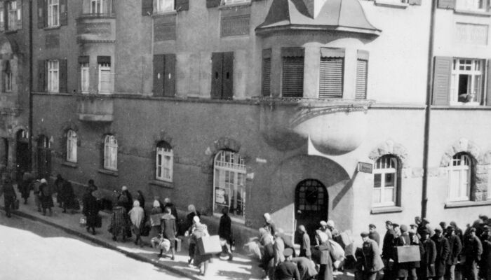 labourers waiting in front of building